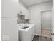 Functional laundry room with modern appliances, ample storage cabinets, and convenient access to adjacent areas at 16739 Cattle Hollow Ln, Noblesville, IN 46060