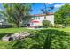 Spacious backyard featuring a stone patio, fire pit, lush greenery, and ample space for outdoor activities at 1783 Trillium Ct, Avon, IN 46123