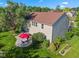 Expansive backyard with mature trees, a stone patio, and a vibrant red umbrella creates a relaxing outdoor space at 1783 Trillium Ct, Avon, IN 46123