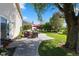 Inviting backyard patio with outdoor seating, lush lawn, and mature trees at 1783 Trillium Ct, Avon, IN 46123