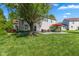 Lush backyard with a patio, outdoor seating, well-manicured lawn, and mature trees for privacy at 1783 Trillium Ct, Avon, IN 46123