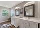 Bright bathroom features double sinks with white vanities, modern lighting, and hardwood flooring at 1783 Trillium Ct, Avon, IN 46123