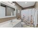 Neutral-toned bathroom features white floral shower curtain, toilet and a white single vanity at 1783 Trillium Ct, Avon, IN 46123