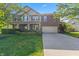 Charming two-story home featuring a brick facade, well-manicured lawn, and a two-car garage at 1783 Trillium Ct, Avon, IN 46123