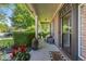 Inviting front porch with comfortable seating, potted plants, and a 'You're Here' welcome mat at 1783 Trillium Ct, Avon, IN 46123