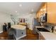 Well-lit kitchen with wood floors, stainless appliances, ample countertops, and breakfast bar at 1783 Trillium Ct, Avon, IN 46123
