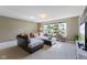 Bright living room with large sectional sofa, carpeted floor, and decorative plants at 1783 Trillium Ct, Avon, IN 46123