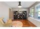 Cozy living room with hardwood floors, built-in shelving, and a sunny window seat at 1783 Trillium Ct, Avon, IN 46123