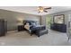 Serene main bedroom features ceiling fan, large bed, neutral decor, and a sitting area at 1783 Trillium Ct, Avon, IN 46123