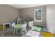 room with carpet flooring, a large window, and a small table with chairs at 1783 Trillium Ct, Avon, IN 46123