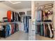 Spacious walk-in closet with custom shelving, carpet flooring, and a mirror at 1783 Trillium Ct, Avon, IN 46123