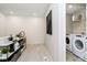 Upstairs hallway with view of a laundry room with modern washer and dryer at 18763 Moray St, Westfield, IN 46074