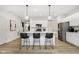 Kitchen with bar seating featuring stainless appliances, quartz counters, and pendant lighting at 18763 Moray St, Westfield, IN 46074