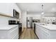 Galley style kitchen featuring white cabinets, stainless appliances, and light wood floors at 18763 Moray St, Westfield, IN 46074