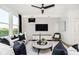 Cozy living room with modern accents, natural light, and a sleek ceiling fan at 18763 Moray St, Westfield, IN 46074