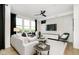 Bright and airy living room featuring modern decor, large windows, and a ceiling fan at 18763 Moray St, Westfield, IN 46074