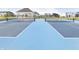 Bright blue and grey tennis court in a residential community, ready for a friendly match at 18763 Moray St, Westfield, IN 46074