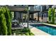 Captivating backyard pool area featuring a dining space under a pergola and multiple lounge chairs at 2036 Central Ave, Indianapolis, IN 46202