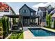 Inviting backyard with a pool, lounge chairs, pergola covered dining area, and manicured landscaping for relaxation at 2036 Central Ave, Indianapolis, IN 46202