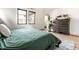 Relaxing bedroom features a textured rug, modern dresser, and two large windows at 2036 Central Ave, Indianapolis, IN 46202