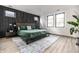Serene primary bedroom showcasing a decorative wall, hardwood floors, and ample natural light at 2036 Central Ave, Indianapolis, IN 46202