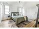Cozy bedroom with a minimalist style featuring a comfortable bed and neutral color scheme with lots of natural light at 2036 Central Ave, Indianapolis, IN 46202