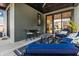 Inviting covered patio with comfortable seating, perfect for outdoor dining and relaxation with stylish decor and finishes at 2036 Central Ave, Indianapolis, IN 46202