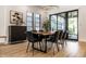 Bright dining area features a wooden table, black chairs, and sliding glass doors to outdoor patio at 2036 Central Ave, Indianapolis, IN 46202