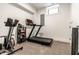 Bright exercise room with a treadmill and rowing machine, perfect for staying active and healthy in the comfort of your home at 2036 Central Ave, Indianapolis, IN 46202