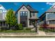 Charming two-story home with black trim, landscaped yard, and an inviting front porch at 2036 Central Ave, Indianapolis, IN 46202