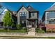 Charming two-story home with black trim, landscaped yard, and an inviting front porch at 2036 Central Ave, Indianapolis, IN 46202