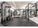 Well-equipped home gym featuring state-of-the-art equipment, mirrors, and rubber flooring for a complete workout experience at 2036 Central Ave, Indianapolis, IN 46202