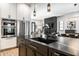Open-concept kitchen flows into living spaces, featuring stainless steel appliances and black countertops at 2036 Central Ave, Indianapolis, IN 46202