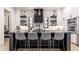 Modern kitchen boasts black countertops, a marble backsplash, and a central island with bar stool seating at 2036 Central Ave, Indianapolis, IN 46202