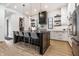 Open-concept kitchen with stainless steel appliances, a large island with seating, and white cabinets at 2036 Central Ave, Indianapolis, IN 46202