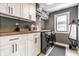 Well-organized laundry room with modern appliances, plenty of counter space, and storage cabinets at 2036 Central Ave, Indianapolis, IN 46202