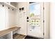 Mud room featuring built-in storage, bench seating, and direct access to the backyard pool area at 2036 Central Ave, Indianapolis, IN 46202