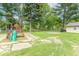 Lush backyard featuring mature trees, green grass, and a play area for outdoor enjoyment at 212 W Banta Rd, Indianapolis, IN 46217