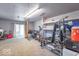 Spacious basement featuring gym equipment, a comfortable sofa, and ample storage space at 212 W Banta Rd, Indianapolis, IN 46217