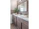 Bathroom with wood paneling, a granite countertop vanity, and a decorative mirror at 212 W Banta Rd, Indianapolis, IN 46217