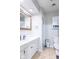 Bright bathroom featuring a white vanity with a geometric-patterned backsplash and a gold-trimmed mirror at 212 W Banta Rd, Indianapolis, IN 46217