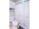 Bathroom featuring a marble-patterned shower curtain and a white toilet with built-in shelving at 212 W Banta Rd, Indianapolis, IN 46217