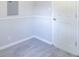 A bedroom featuring gray wainscoting, neutral walls, carpeted floors, and a white door at 212 W Banta Rd, Indianapolis, IN 46217