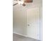 A bedroom showcasing neutral walls and trim, a ceiling fan, and a white door at 212 W Banta Rd, Indianapolis, IN 46217