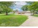 Lovely single-story home with a well-kept lawn and a long driveway at 212 W Banta Rd, Indianapolis, IN 46217