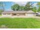 Charming single-story home with a well-manicured front lawn, a garage, and red-trimmed windows at 212 W Banta Rd, Indianapolis, IN 46217