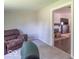 Living Room has neutral walls, carpet and view into an adjacent room at 212 W Banta Rd, Indianapolis, IN 46217