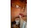 A small, enclosed bathroom with sink, mirror, and a toilet at 2221 Station St, Indianapolis, IN 46218