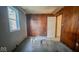 Bedroom with wood paneling, window, and a door at 2221 Station St, Indianapolis, IN 46218