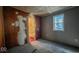 Bedroom with wood paneling, window, and a bathroom at 2221 Station St, Indianapolis, IN 46218